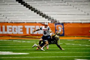 Syracuse midfielder Luke Schwasnick has made a name for himself by laying his 6-foot-1, 228-pound body into opposing players, especially when running in from the faceoff wing.