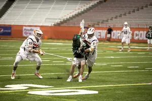 Luke Schwasnick crunches a Binghamton player on Wednesday. Syracuse hounded the Bearcats and allowed just five goals. 