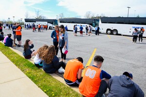 Syracuse fans wait outside the buses during a stop on their way to the Final Four in Houston on Friday. 
