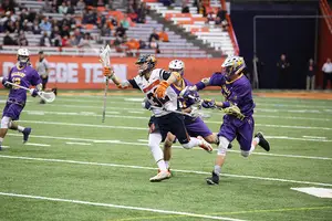 Syracuse's Tom Grimm attempts to clear the ball during SU's matchup with Albany on Feb. 21. The two teams will face each other again in the first round of the NCAA tournament on Sunday at 7:30 p.m.