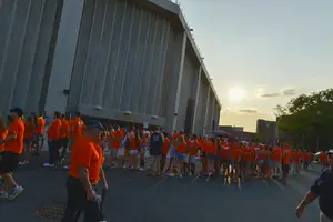Students mill outside the Carrier Dome before football game. The stadium is the largest indoor stadium on any college campus. 