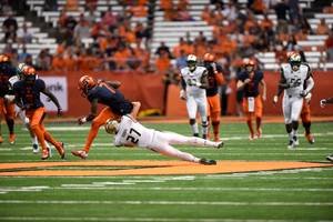 A South Florida defender drags down Amba Etta-Tawo on Saturday in the Carrier Dome. SU lost by 25 points.