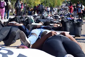 About 200 Syracuse University community members laid down on the University Place promenade as part of a die-in on Wednesday. This demonstration was done to bring attention to police brutality specifically toward people of color.