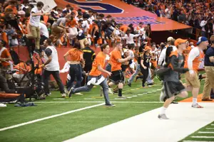 Syracuse fans stormed the field after beating Virginia Tech. Check out what our beat writers think about people rushing the field after wins. 