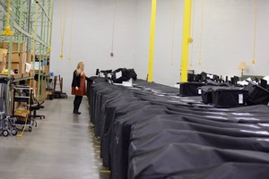 Julie Cook, a secretary at the Onondaga County Board of Elections' office, looks at voting machines in the BOE's warehouse. Cook is a former voting machine technician. 