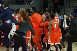 The Orange bench crowded Tyus Battle after he drained the game-winning bucket against Clemson.