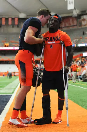 Syracuse QB Eric Dungey (left) embraced Cordy after the game. Cordy, who missed most of 2016 due to injury, left in the middle of the first quarter Friday and did not return. 