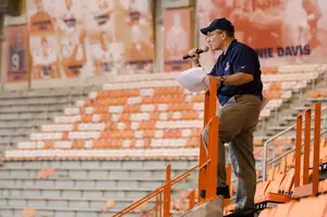 Timothy Diem, who was recently named as the new director of athletic bands, looks out onto the Carrier Dome field.