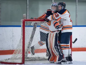 Megan Quinn hugs goalkeeper Abbey Miller after a 3-0 win over Penn State on Nov. 10. The Orange has halted its nonconference skid and has not lost in College Hockey America. 