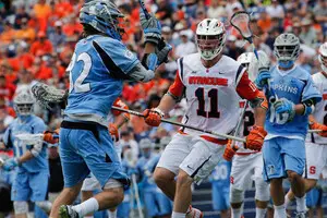 Brandon Mullins face guards a Johns Hopkins offensive player at Syracuse. Two years later, Mullins appeared in the Major League Lacrosse All-Star Game.