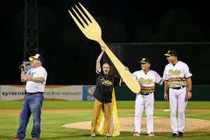 Rochester on-field host Grant Anderson holds up the Golden Fork along Syracuse general manager Jason Smorol (left), Rochester Pitching coach Stu Cliburn (right) and Rochester manager Joel Skinner (far right).