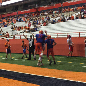 Steven Barrett (No. 2) gets mobbed by two teammates after scoring his first touchdown on Thursday. 