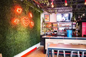 The signature neon sign lights up the well-embellished walls and a fully-stocked bar at XO Taco, the new Mexican-American restaurant on East Fayette Street.