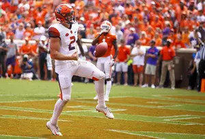 Eric Dungey flips the ball to a referee after scoring on a one-yard rushing touchdown that put Syracuse up 10 in Death Valley.