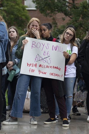 Freshmen Abigail Tick and Nicole Aramboles react to one of the women speaking at the walkout.