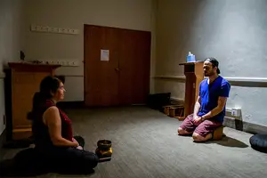 Joanne Cooke (left) and Andrew Maloney (right) sit in the small chapel in the basement of Hendricks Chapel for a meditation session.