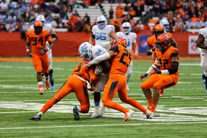 Kielan Whitner (25) helps wrap up a North Carolina ball carrier on Saturday during SU's win at the Carrier Dome.