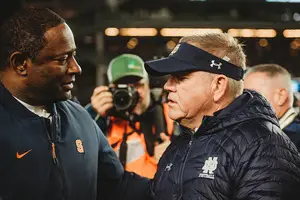 Dino Babers and Notre Dame head coach Brian Kelly met at midfield after UND blew out Syracuse at Yankee Stadium.