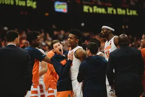 Teammates surround Tyus Battle after he hit the game-winning jumper to beat Georgetown.