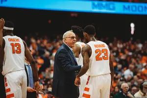 Jim Boeheim talks to Frank Howard on the sideline during SU's matchup with Cornell.