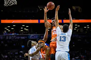 Tyus Battle meets two North Carolina defenders at the rim in Syracuse's 2018 ACC Tournament matchup with the Tar Heels.