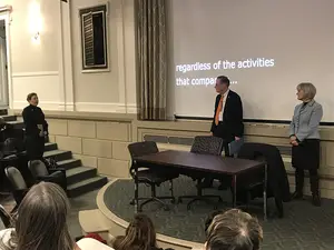 Professor Janice Dowell (left) asked Chancellor Kent Syverud about the Board of Trustees' decision-making process at Wednesday's open forum. 