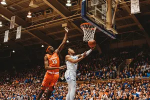 Paschal Chukwu tries to block a Duke player at the rim.