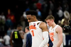 Oshae Brissett and Buddy Boeheim walk off the court after losing in the first round of the NCAA Tournament.