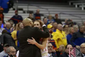 Tiana Mangakahia and Quentin Hillsman embrace after Mangakahia checks out against South Dakota State in what could be her final collegiate game. 
