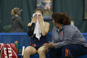 Sofya Golubovskaya, pictured on Sunday, talks with associate head coach Shelley George. She lost in straight-sets.  