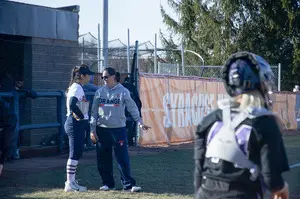 Shannon Doepking stands with freshman Anya Gonzalez on the third-base line at Skytop Stadium. 