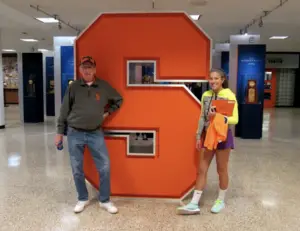 John Prichard poses with his granddaughter, Alicia Hansen, in Manley Field House.
