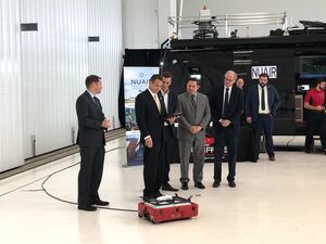 Gov. Andrew Cuomo tests out a drone at a press conference on Tuesday. Syracuse Mayor Ben Walsh and County Executive Ryan McMahon. 