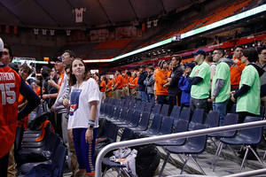 Members of the student section from Wednesday's game stand from their seats.