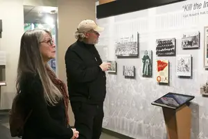 Sandy Bigtree (left) and Philip Arnold (right) view installation at Skä·noñh — Great Law of Peace Center. 