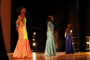 Left to right, Louisa Williams, Ifechukwu Uche-Onyilofor and Nafissatou Camara  stand on stage before Miss Africa is crowned. 