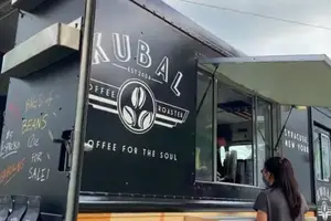 A customer waits to order at the Cafe Kubal mobile cafe. 