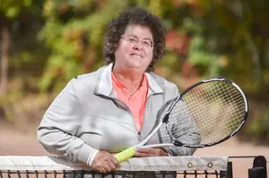 Former SU tennis player Abbe Seldin, who faced gender discrimination as a tennis player in high school, poses with a tennis racket.  