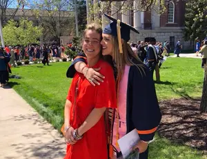 Laurie Beth (left) and Caroline Koller embracing at Caroline’s graduation from SU in 2015.