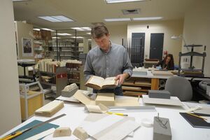 The vast archive on the sixth floor of Bird Library holds priceless materials, such as published work of SU graduates from over 100 years ago. 