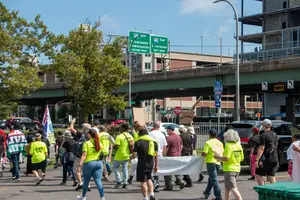 Community members march past I-81 as they walk from Dr. King Elementary School to the New York state office building in downtown Syracuse, demanding economic, racial and environmental justice for the impacts of I-81.