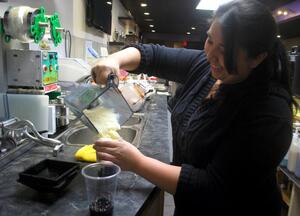 Glenda Nunez, owner of Boba Suite Tea House, prepares a drink. The tea house must raise $10,000 by April 15 in order to continue to stay open and operating.