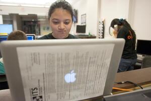 Shefali Haldar, a senior information management and technology major and consultant for ITS, reacts as she fixes one of the many MacBooks infected by the flashback virus on campus.