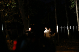 Officer Mike Gabriell walks two people out of Thornden Park after responding alongside the Syracuse Police Department.
