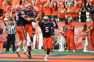 Syracuse wide receivers Christopher Clark, (36), Marcus Sales, (5), and tight end Beckett Wales, (85), celebrate a touchdown. 