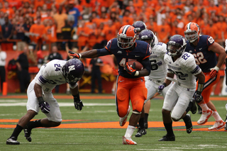 Syracuse running back Jerome Smith finds a hole against defenders.