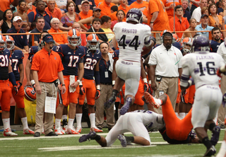 Northwestern linebacker Chi Chi Ariguzo intercepts a pass in the first half in front of the Syracuse sideline.