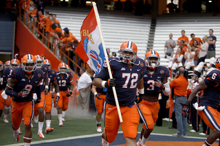Offensive lineman Ivan Foy runs out of the tunnel with his SU teammates.