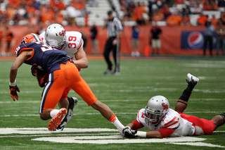 Syracuse wide receiver Chris Clark is tackled by a SBU defender.