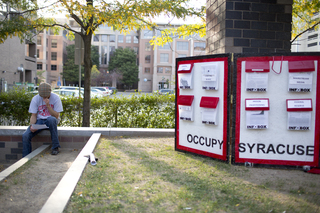 A supporter reads pamphlets provided by members of Occupy Syracuse. 